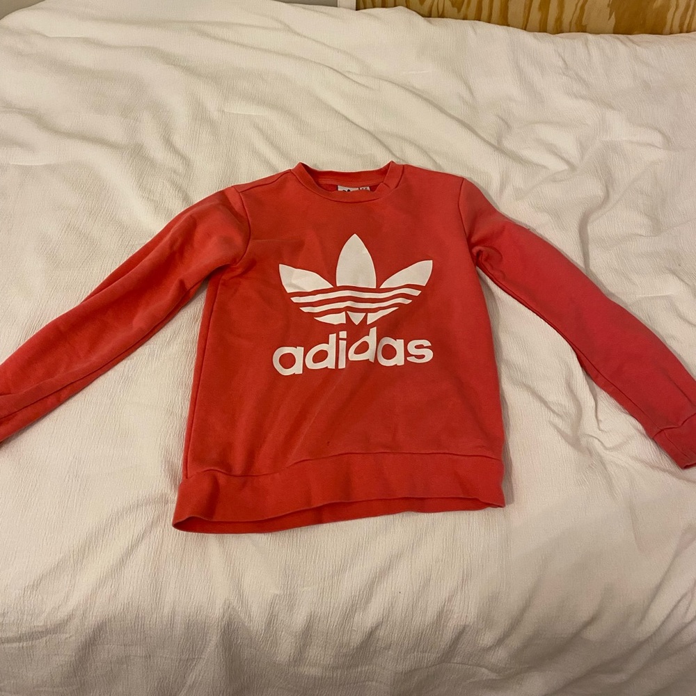 This is an Addias Sweatshirt and is peachy pink color and is very comfortable!